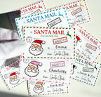 Hand holding a fan of personalized Santa Mail labels in several color themes, each with a child's name