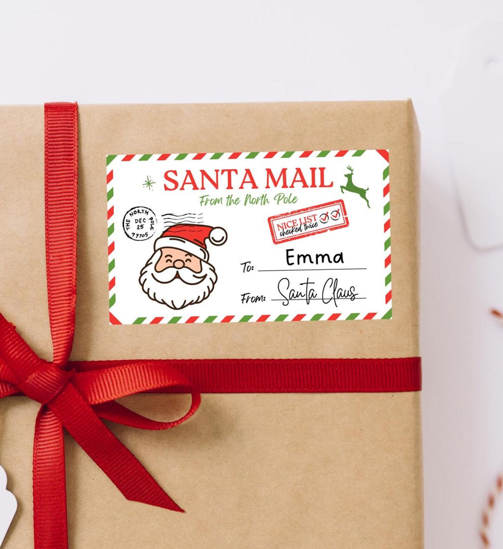 Santa Mail gift label addressed to Emma from Santa Claus on a kraft-wrapped present with a red ribbon